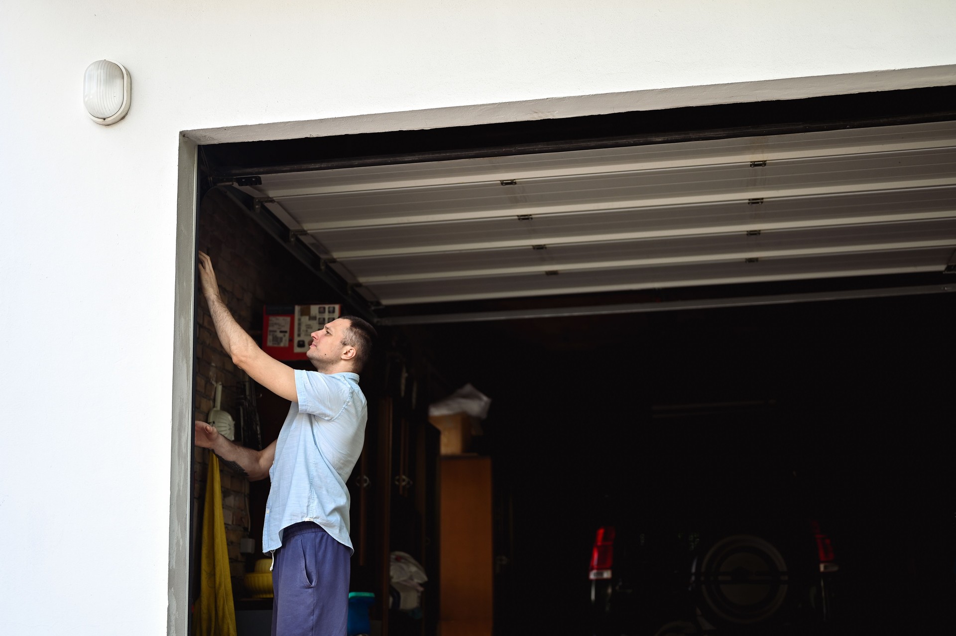 mid adult man repairing garage in a yard.